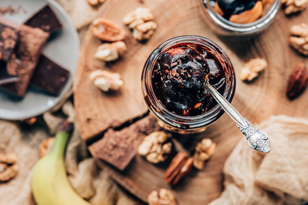top view of sweet tasty chocolate dessert in glass jar with spoon  の写真素材