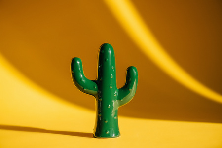 close-up view of green ceramic cactus sculpture on yellow の写真素材