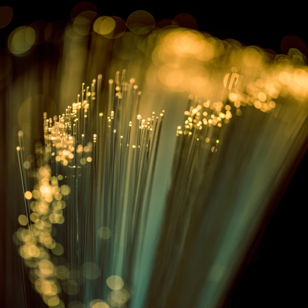 selective focus of shiny yellow fiber optics texture backgroundの写真素材