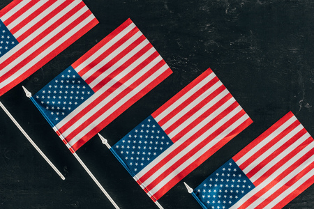 top view of arranged american flags on dark surfaceの写真素材