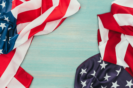 top view of folded american flags on blue wooden surface