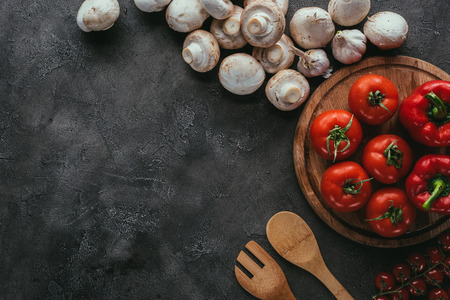 top view of raw tomatoes and mushrooms for pizza on concrete tableの写真素材