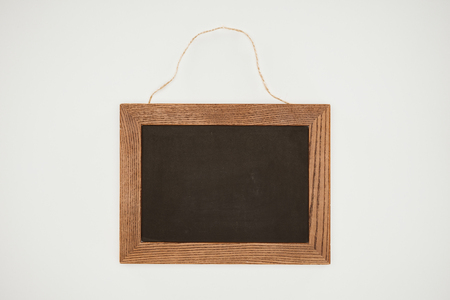 blank chalkboard with wooden frame and thread isolated on whiteの写真素材