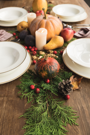close-up view of beautiful autumn decor and cutlery on rustic wooden tableの写真素材