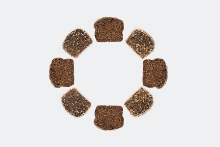 top view of round frame from homemade bread slices isolated on greyの写真素材