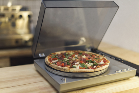 selective focus of pizza on vintage vinyl record player