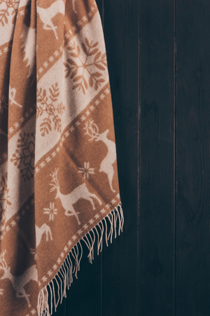 warm scarf with deer and snowflakes ornament hanging on wallの写真素材