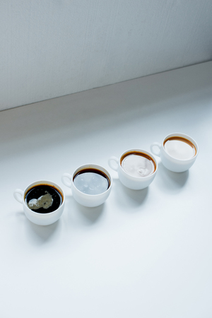 different kinds of coffee in row on white table, close-up viewの写真素材