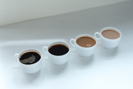 different kinds of coffee in row on white table, close-up viewの写真素材
