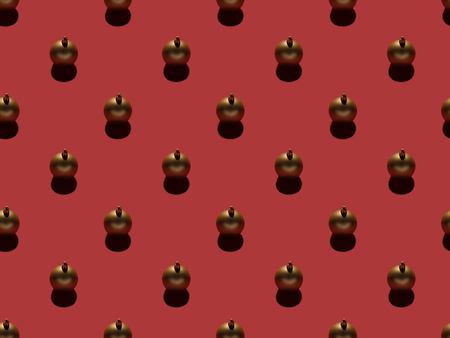 full frame of arranged golden christmas balls isolated on redの写真素材