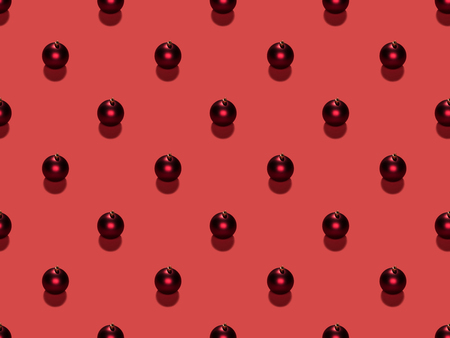 full frame of arranged christmas balls isolated on redの写真素材