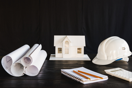 close up view of house model and various architecture equipment on wooden tabletopの写真素材