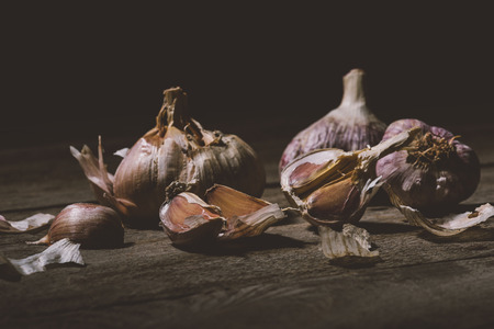 close-up view of raw healthy garlic cloves on wooden table 