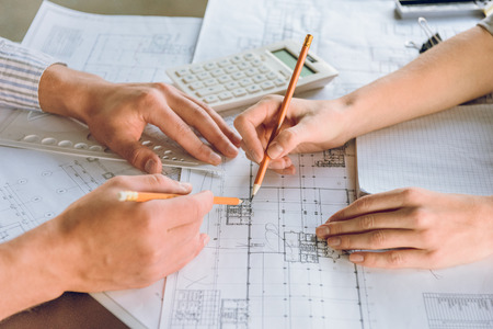 cropped shot of architects working on new plan together