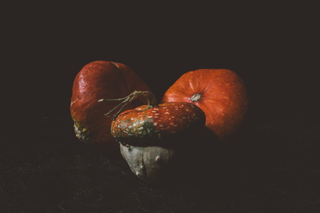 close-up view of ripe organic squashes on black の写真素材