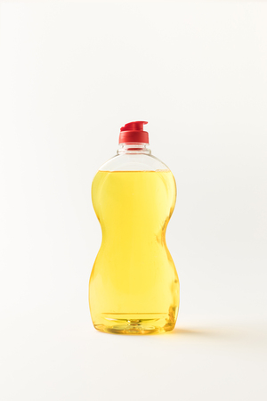 close-up view of plastic bottle of yellow cleaning fluid isolated on white  の写真素材