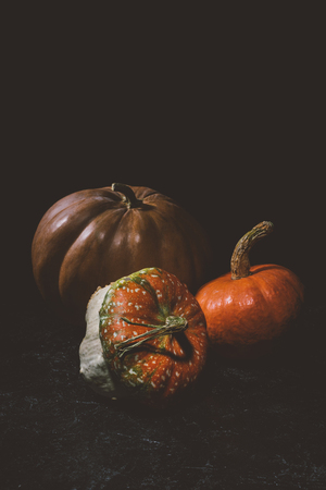 close-up view of ripe organic pumpkins on black の写真素材