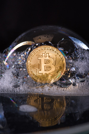 close up view of golden bit coin in soap bubbleの写真素材