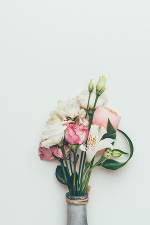 close-up view of beautiful tender flower bouquet in bottle isolated on greyの写真素材