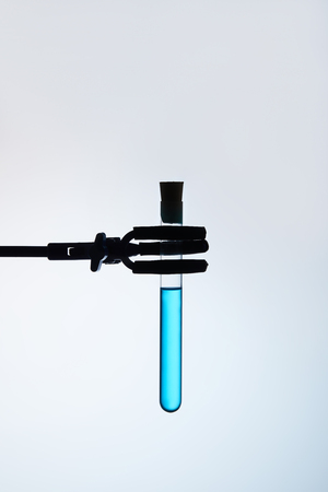test tube filled with blue liquid on stand