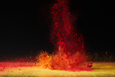 orange holi powder explosion on black, Hindu spring festivalの写真素材