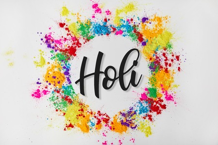 circle frame of colorful traditional paint with Holi sign, isolated on white, Hindu spring festival of coloursの写真素材