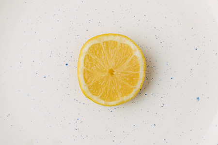 Half of juicy lemon on plate