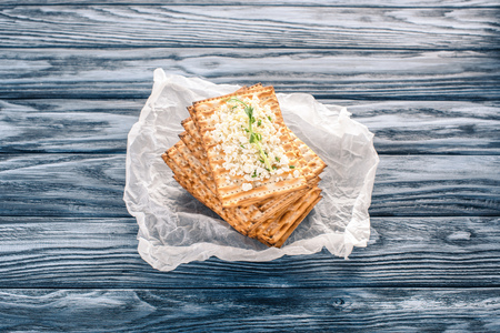 top view of crispy crackers with topping of cottage cheese on wooden table