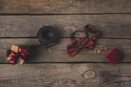 flat lay with wedding accessories, gift and bridal bouquet on wooden surfaceの写真素材