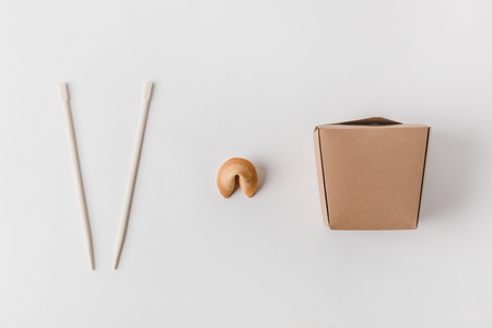 top view of noodles box with chopsticks and chinese fortune cookieの写真素材