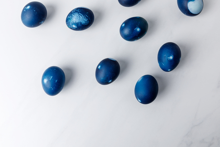 top view of blue painted easter eggs on white surfaceの写真素材