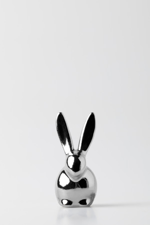 silver statuette of easter bunny on whiteの写真素材