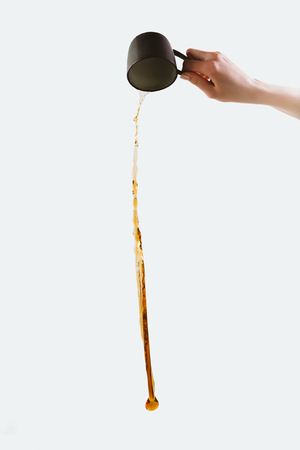 cropped view of hand pouring out coffee, isolated on whiteの写真素材