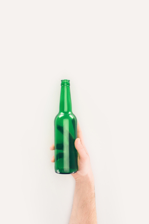 cropped shot of man holding empty beer bottle isolated on whiteの写真素材