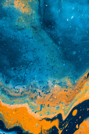 orange and blue background with oil paint の写真素材