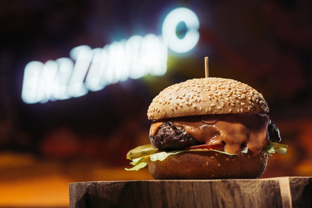 close-up view of delicious beef burger on wooden stumpの写真素材