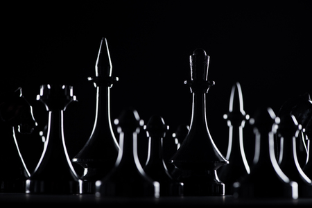 silhouettes of chess figures isolated on black, business conceptの写真素材