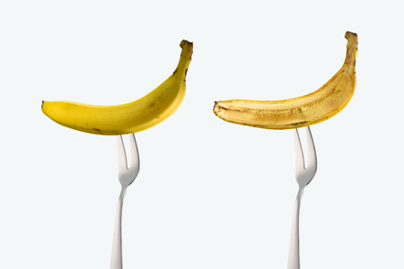 bananas on forks isolated on whiteの写真素材