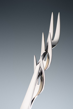 three forks with two tines isolated on grey