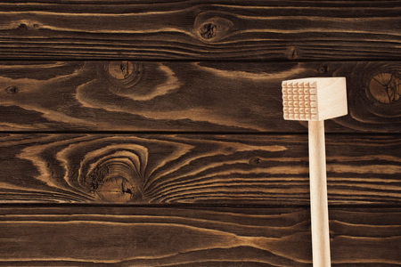 top view of wooden meat mallet on table 