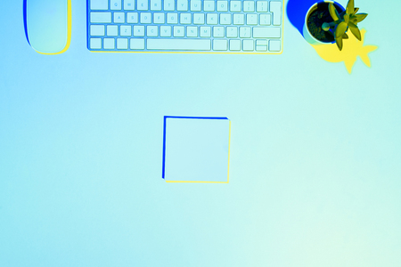 blue toned picture of computer keyboard and mouse, plant ant sticky note の写真素材