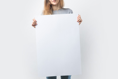 partial view of woman with blank banner in handsの写真素材