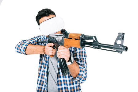 young african american man in checkered shirt and virtual reality headset holding rifle isolated on white の写真素材