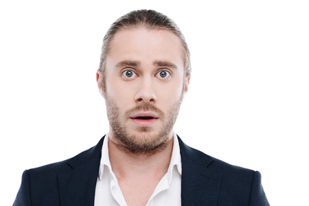 handsome shocked businessman in suit, isolated on whiteの写真素材