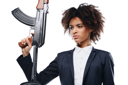 portrait of beautiful african american female killer with rifle, isolated on whiteの写真素材