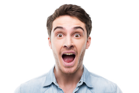 portrait of excited handsome man looking at camera, isolated on white