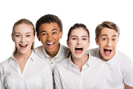 portrait of screaming multiethnic teenagers in white shirts isolated on white