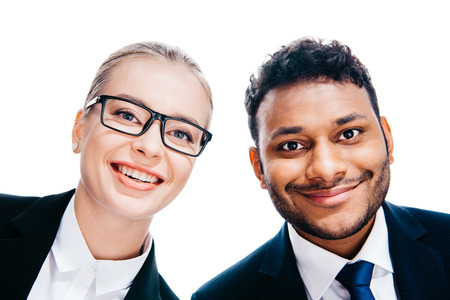 smiling multiethnic businesspeople in formal wear looking at camera, isolated on white  の写真素材