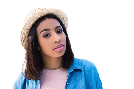 portrait of beautiful african american woman in straw hat looking at camera isolated on whiteの写真素材