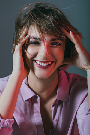 beautiful cheerful girl looking at camera, isolated on greyの写真素材